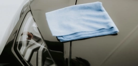 PPF film coating service providing 4-micron self-healing protection for vehicles, including bumpers and mirrors, at Absolutely Mint Auto Detailing