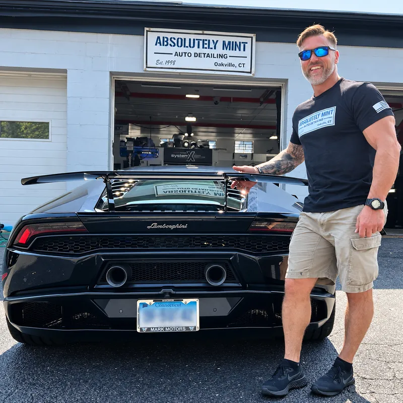 Tony Mint with a car outside Absolutely Mint Auto Detailing in Oakville